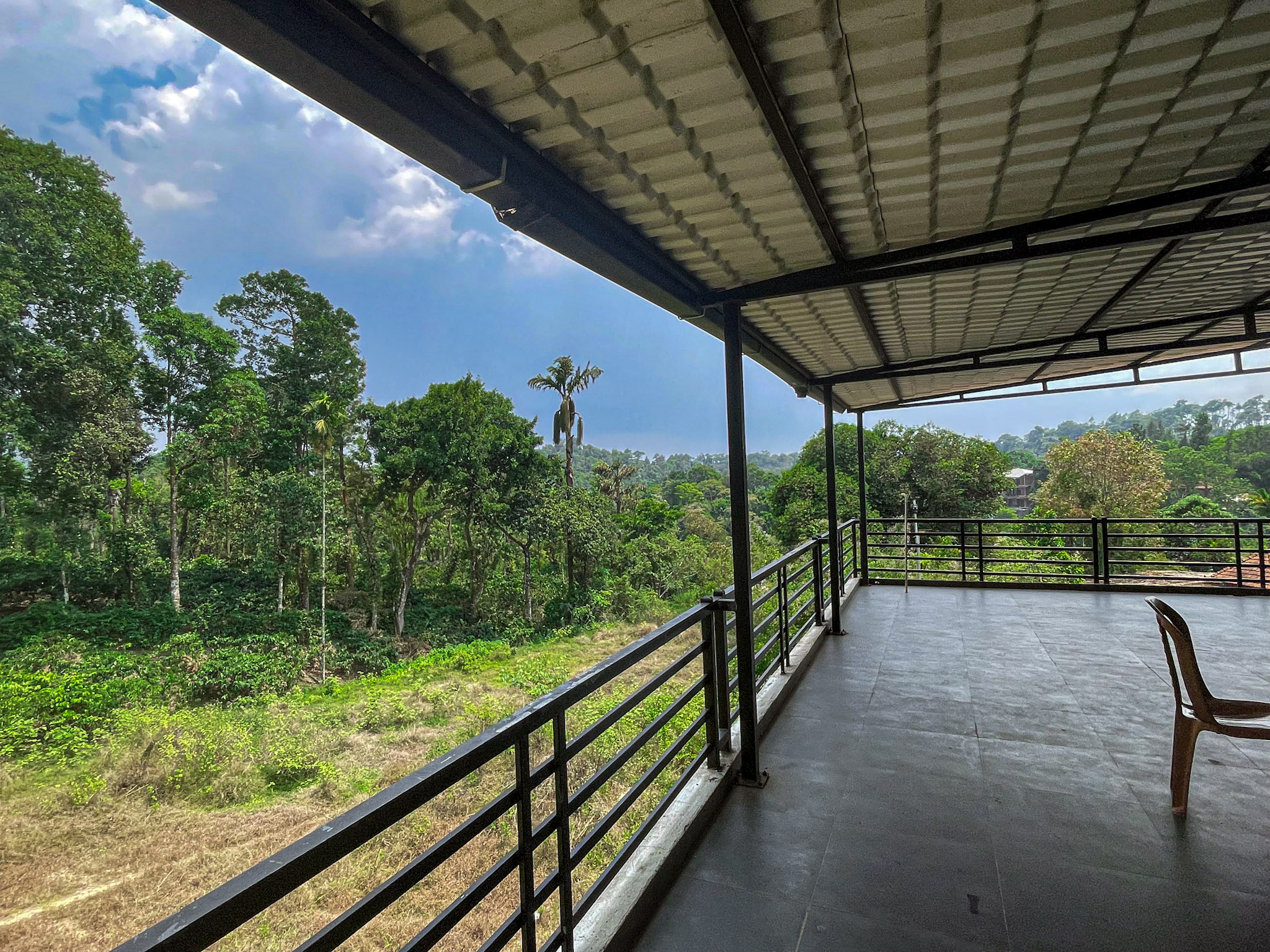 Nature Valley Homestay veranda overlooking the green landscape